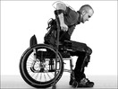 Man wearing exoskeleton rising from wheelchair