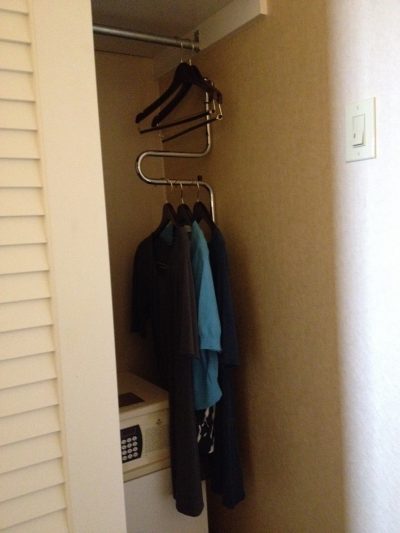 Lowered closet rail in hotel room